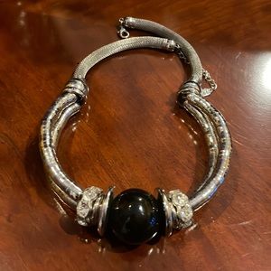 Fashion necklace with a large black shiny stone in the middle.